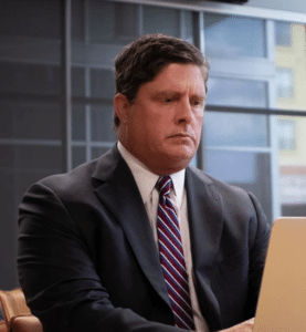 John Helms Dallas federal drug crime lawyer focused on laptop.